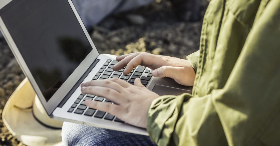 Cropped close up of female organic farmer typing on laptop Cropped close up of female organic farmer typing on laptop 