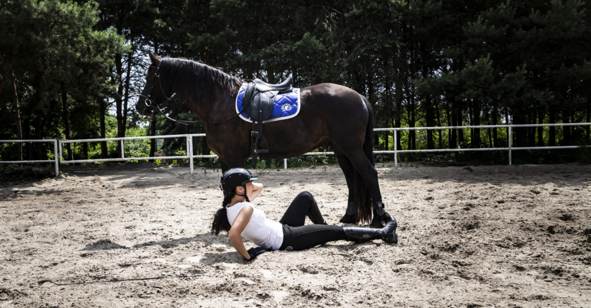 Falling from a horse. Riding accident. Injured woman The woman rider fell off his horse. 