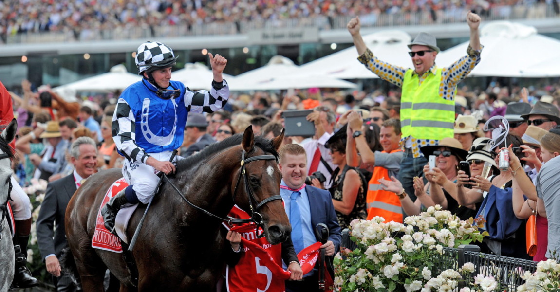 Melbourne Cup 2014 epa04475469 Jockey Ryan Moore riding Protectionist celebrates after crossing the finish line and winning the Melbourne Cup race at Flemington Racecourse in Melbourne, Australia, 04 November 2014. The Melbourne Cup day, sporting several horse races including the world's richest two mile (3,200 meter) race, is cause for major celebrations and betting across Australia. The main race is said to 'stop a nation' and many revellers in fancy clothing attend the races at the Flemington racecourse. EPA/TRACEY NEARMY AUSTRALIA AND NEW ZEALAND OUT ++ 