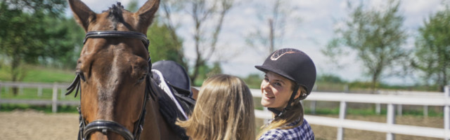 Two,Young,Women,In,Plaid,Shirts,Prepare,A,Horse.,High-quality two young women in plaid shirts prepare a horse. High-quality photo 