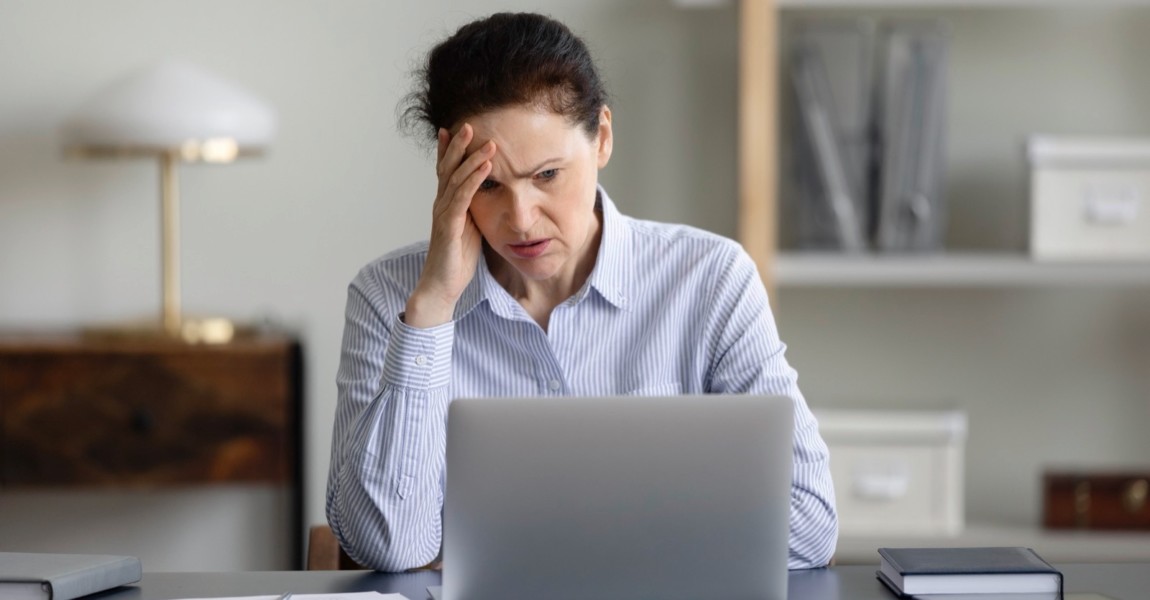 Frustrated stressed senior business woman using laptop Frustrated stressed senior business woman using laptop, looking at screen in shock, feeling upset, panic, realizing mistake, error, failure, problem, getting bad news, touching head 