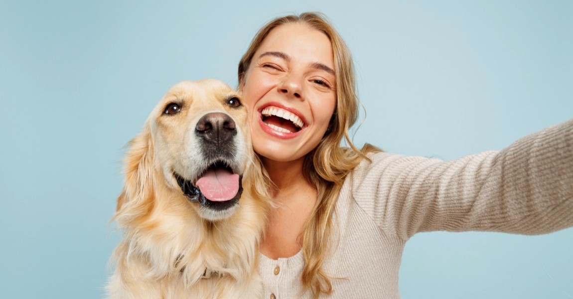 Close up young owner woman with her best friend retriever dog wear casual clothes do selfie shot on mobile cell phone wink isolated on plain pastel light blue background. Take care about pet concept. Close up young owner woman with her best friend retriever dog wear casual clothes do selfie shot on mobile cell phone wink isolated on plain pastel light blue background. Take care about pet concept 