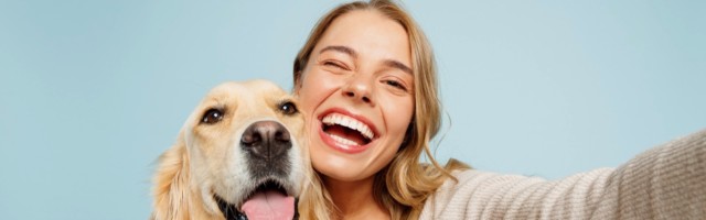 Close up young owner woman with her best friend retriever dog wear casual clothes do selfie shot on mobile cell phone wink isolated on plain pastel light blue background. Take care about pet concept. Close up young owner woman with her best friend retriever dog wear casual clothes do selfie shot on mobile cell phone wink isolated on plain pastel light blue background. Take care about pet concept 